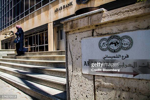 Sign sits on display outside the headquarters of Arab Bank PLC in the financial district in Amman, Jordan, on Sunday, July 21, 2013. Jordanian...