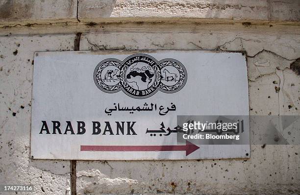 Sign sits on display outside the headquarters of Arab Bank PLC in the financial district in Amman, Jordan, on Sunday, July 21, 2013. Jordanian...