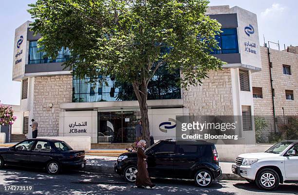 Pedestrian passes a branch of Jordan Commercial Bank in the financial district in Amman, Jordan, on Sunday, July 21, 2013. Jordanian internal debt...