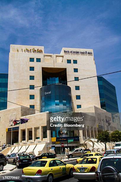 Automobiles pass the headquarters of the Bank of Jordan in the financial district in Amman, Jordan, on Sunday, July 21, 2013. Jordanian internal debt...