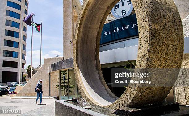Stone sculpture sits in front of the headquarters of the Bank of Jordan in Amman, Jordan, on Sunday, July 21, 2013. Jordanian internal debt has...