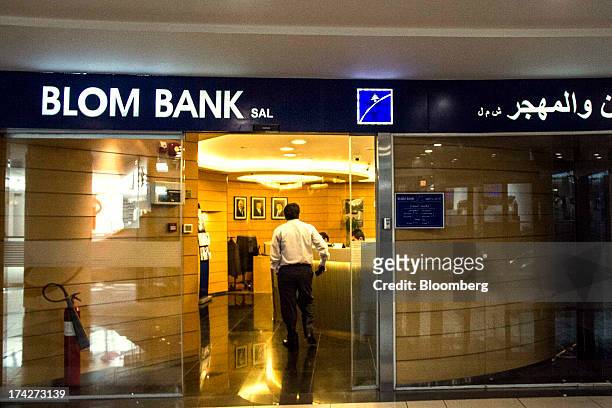 Customer enters a branch of Blom Bank SAL inside the Taj shopping mall in Amman, Jordan, on Sunday, July 21, 2013. Jordanian internal debt has...