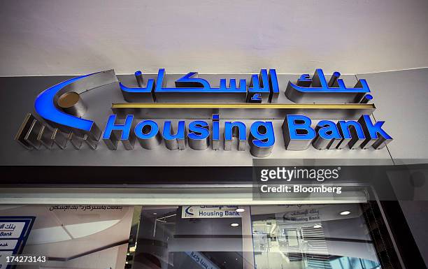 Logo sits on display outside a branch of the Housing Bank for Trade & Finance inside the Taj shopping mall in Amman, Jordan, on Sunday, July 21,...
