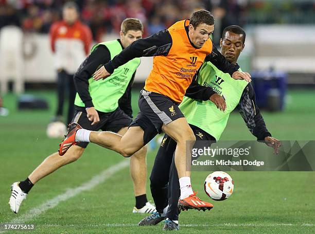 Stewart Downing kicks the ball past Andre Wisdom during a Liverpool FC training session at Melbourne Cricket Ground on July 23, 2013 in Melbourne,...