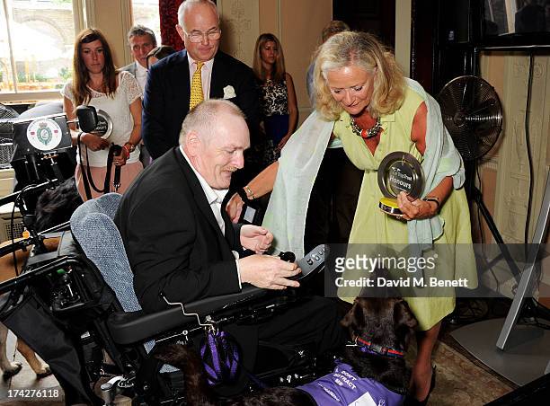 Melvin O'Dowd, owner of Daily Mirror Hero Service dog Alice, meets Dogs Trust Chairman Philip Daubeny and Dogs Trust CEO Clarissa Baldwin at the Dogs...