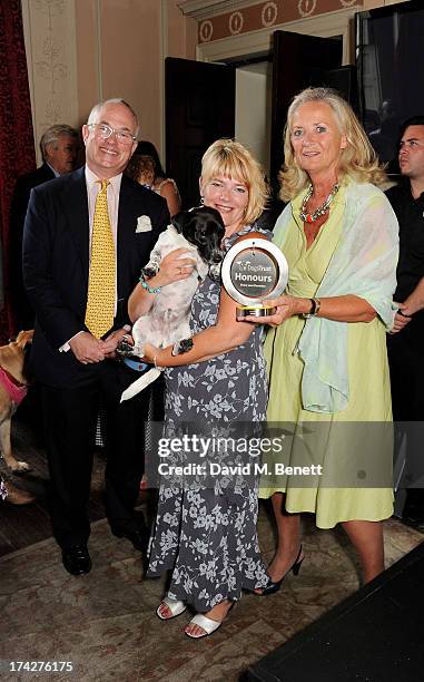 Rosie Foster , owner of Hero Pet Scampi, poses with Dogs Trust Chairman Philip Daubeny and Dogs Trust CEO Clarissa Baldwin at the Dogs Trust Honours...