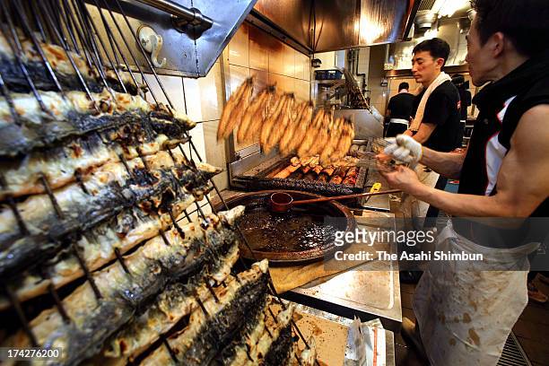 An eel chef cooks 'Kabayaki' eel at a restaurant on July 22, 2013 in Fukuoka, Japan. It is said that people eat eel on the Doyo-no-Ushi-no-Hi, July...