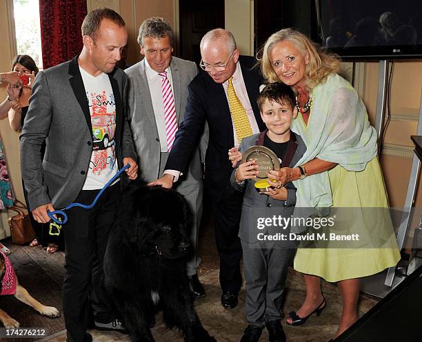 Guest, David Pugh, Dogs Trust Chairman Philip Daubeny and Dogs Trust CEO Clarissa Baldwin pose with Tol and Hero Service Dog Atrayu at the Dogs Trust...