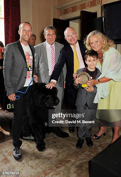 Guest, David Pugh, Dogs Trust Chairman Philip Daubeny and Dogs Trust CEO Clarissa Baldwin pose with Tol and Hero Service Dog Atrayu at the Dogs Trust...