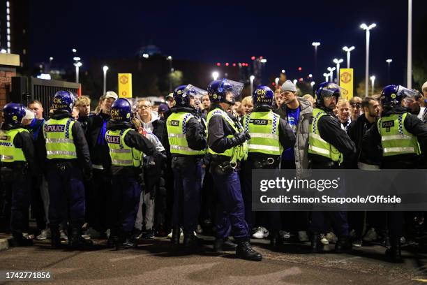 Police hold back the Copenhagen fans ahead of the UEFA Champions League Group A match between Manchester United and F.C. Copenhagen at Old Trafford...