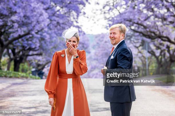 King Willem-Alexander of The Netherlands and Queen Maxima of The Netherlands pose at the Jacaranda Trees on October 18, 2023 in Pretoria, South...