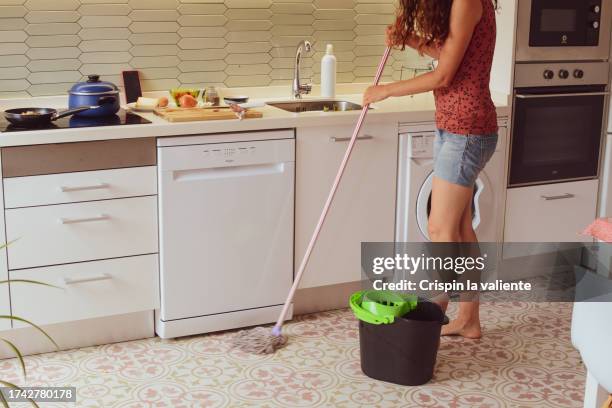 a woman cleaning her kitchen - mop stock pictures, royalty-free photos & images