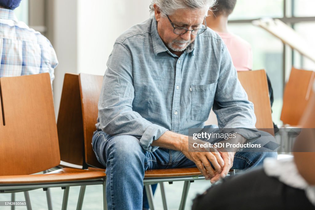Wating Look In Waiting Room Mature Man Looks Down While Praying Quietly High-Res ...