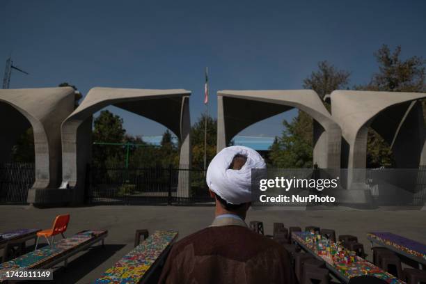 An Iranian cleric stands in front of the main entrance of the University of Tehran, October 24, 2023.