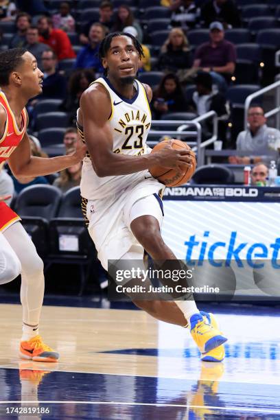 Aaron Nesmith of the Indiana Pacers drives to the basket in the game against the Atlanta Hawks at Gainbridge Fieldhouse on October 16, 2023 in...