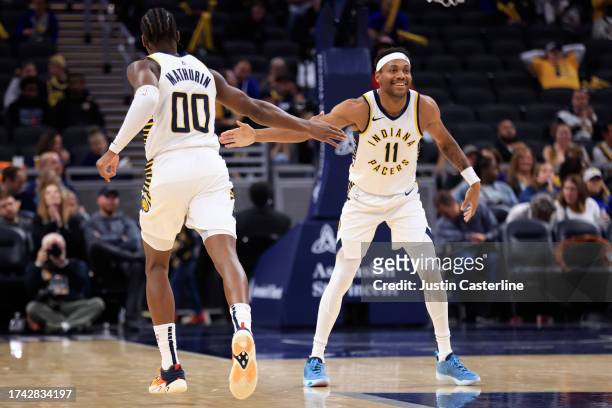 Bennedict Mathurin and Bruce Brown of the Indiana Pacers celebrate a play in the game against the Atlanta Hawks at Gainbridge Fieldhouse on October...