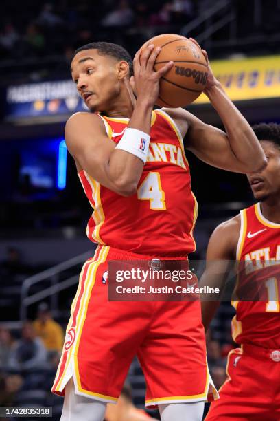 Kobe Bufkin of the Atlanta Hawks rebounds the ball in the game against the Indiana Pacers at Gainbridge Fieldhouse on October 16, 2023 in...