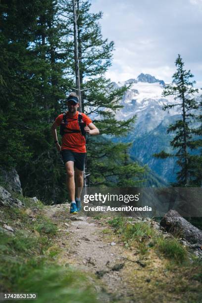 trail runner bounds along mountain trail - athlete bulges stock pictures, royalty-free photos & images