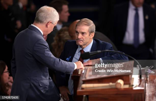 Rep. Jim Jordan talks to Speaker Pro Tempore Rep. Patrick McHenry as the House of Representatives prepares to hold a vote on a new Speaker of the...