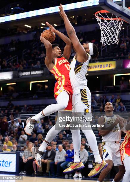 De'Andre Hunter of the Atlanta Hawks takes a shot over Myles Turner of the Indiana Pacers at Gainbridge Fieldhouse on October 16, 2023 in...