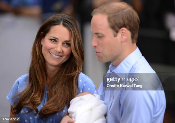 Catherine, Duchess of Cambridge smiles as Prince William, Duke of Cambridge speaks to the media, holding their newborn son, prior to departing the...