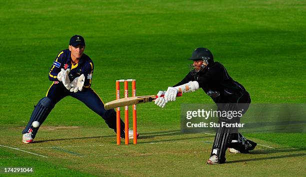 Royals batsman Thilan Samaraweera hits over the top watched by keeper Mark Wallace during the Friends Life T20 match between Glamorgan Dragons and...