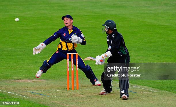 Royals batsman Thilan Samaraweera hits out watched by keeper Mark Wallace during the Friends Life T20 match between Glamorgan Dragons and...