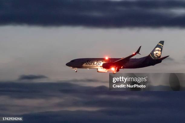 Alaska Airlines Boeing 737-800 aircraft as seen landing at dusk time at Ronald Reagan Washington National Airport DCA in Arlington County, Virginia...