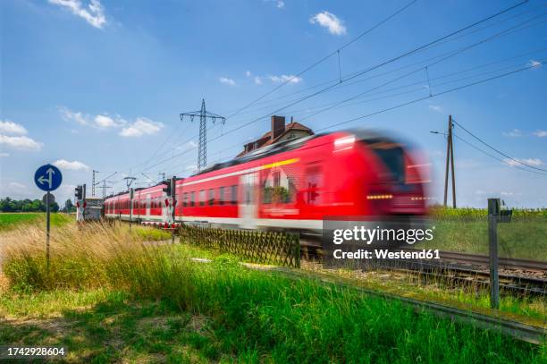 germany, north rhine westphalia, beckrath, blurred motion of red passenger train - nordrhein westfalen stock pictures, royalty-free photos & images