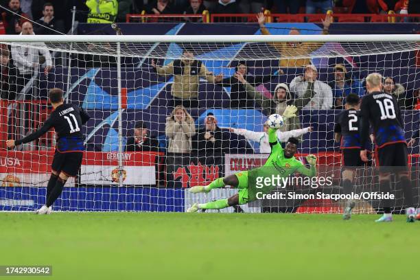 Manchester United goalkeeper Andre Onana saves a last minute penalty from Jordan Larsson of FC Copenhagen to ensure a United win during the UEFA...