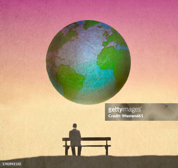 illustration of man sitting alone on bench looking at planet earth floating in background - dividing stock illustrations