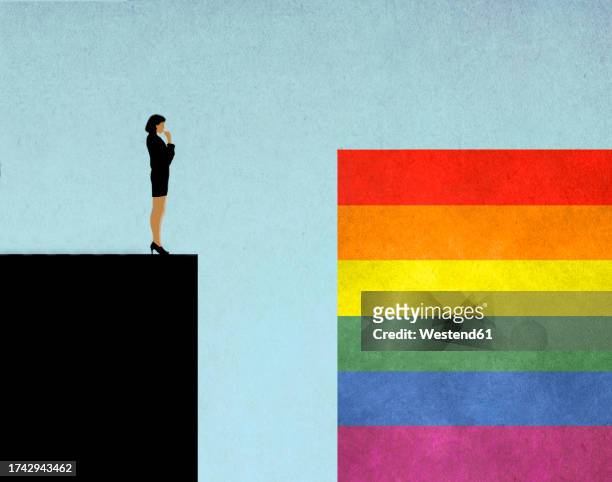 illustration of woman standing at edge of steep cliff looking at rainbow flag on opposite side - business stock illustrations