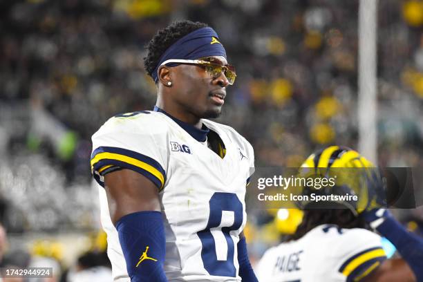 Michigan Wolverines nickelback Mike Sainristil wears a pair of Buffs sunglasses after returning an interception for a touchdown during a college...