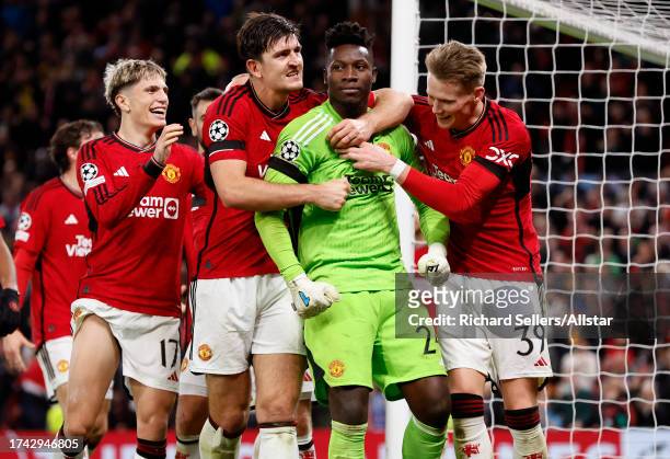 Harry Maguire and Scott McTominay of Manchester United and Andre Onana celebrates last minute save during the UEFA Champions League match between...