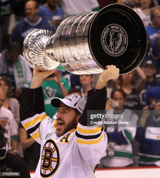 Boston Bruins left wing Mark Recchi hoists the Stanley Cup after the Boston Bruins took on the Vancouver Canucks in Game 7 of the NHL Stanley Cup...