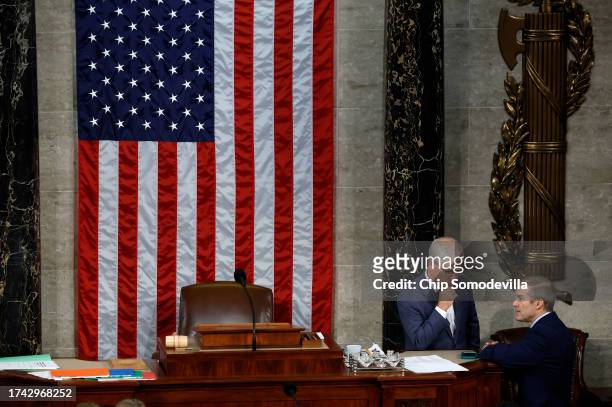 Rep. Jim Jordan talks to Speaker Pro Tempore Rep. Patrick McHenry as the House of Representatives prepares to hold a vote on a new Speaker of the...