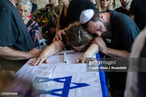 The immediate family of Yitzhak Seitan his wife, Hannah Seitan their son, Tal Seitan and his aunt Pesi Cohen grieve during the funeral at the Hod...