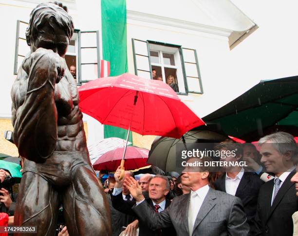 Former California Governor Arnold Schwarzenegger and and Austrian Chancellor Werner Faymann attend on October 7, 2011 the unveiling of a statue...