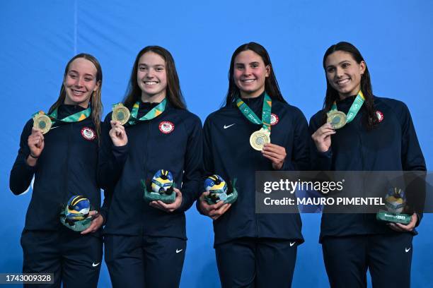 Paige Madden, Camille Spink, Kayla Wilson and Kelly Pash pose with the gold medal during the podium ceremony of the women's 4x200m freestyle relay...