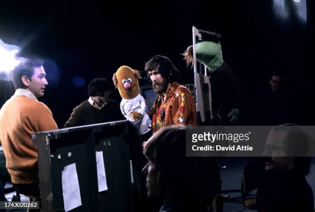 Actor Bob McGrath, an crew member, puppeteer Jim Henson holding an 'Anything Muppet' dentist, puppeteer Daniel Seagren, puppeteer Frank Oz holding an...