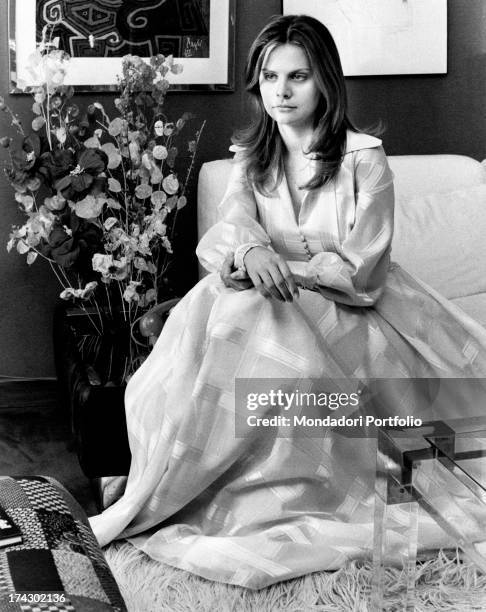 Italian actress Silvia Dionisio sitting on the sofa. Rome, 1970s.