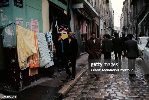 Algerian emigrants in a street of the Arab quarters. Marseille , 1974..