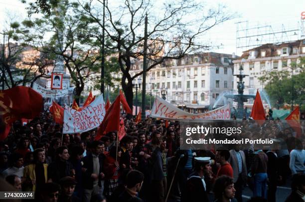 Big communist demostration of workers in a square of Lisbon; some banners writings Long live socialism and Same salary for women . Lisbon , 1974..