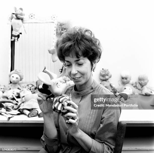 Italian animation artist Maria Perego, inventor of Topo Gigio, looking at a model of the famous puppet. 1960s.