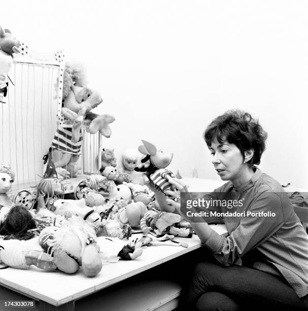 Italian animation artist Maria Perego, inventor of Topo Gigio, looking at a model of the famous puppet. 1960s.