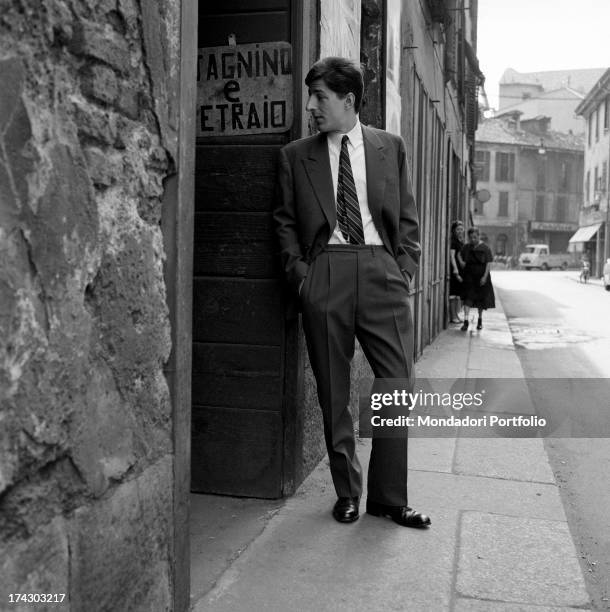 Italian singer-songwriter and actor Giorgio Gaber looking inside a tinsmith's workshop. Milan, 1960s.