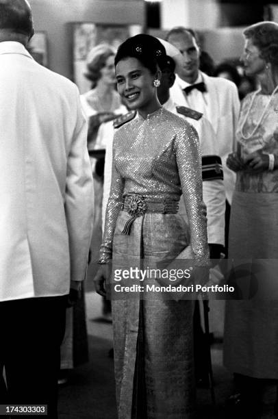 The Queen of Thailand Sirikit wearing an evening dress on the occasion of a concert with works of Johann Sebastian Bach. Bangkok, 1965.