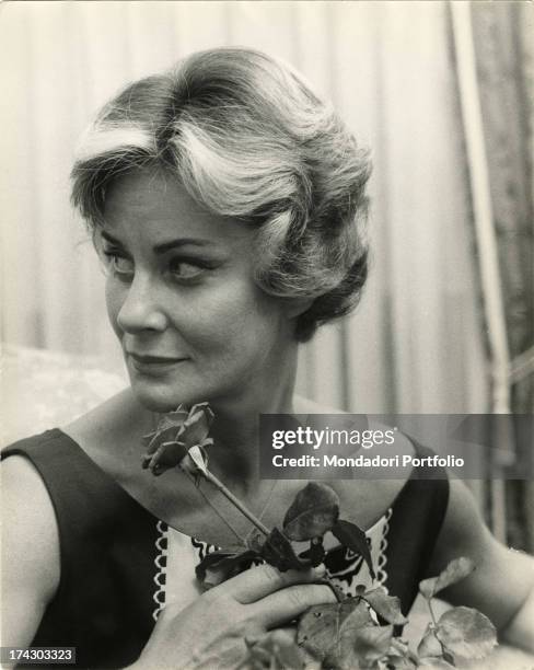 The actress Alida Valli with a rose in her hand, at her birthday party. May 31, 1961..