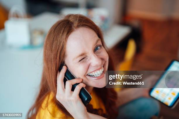 happy woman talking on phone at home - telefone fixo imagens e fotografias de stock
