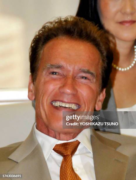 California Governor Arnold Schwarzenegger is all smiles as he talks with Tokyo Governor Shintaro Ishihara at the Tokyo city hall on September 14,...